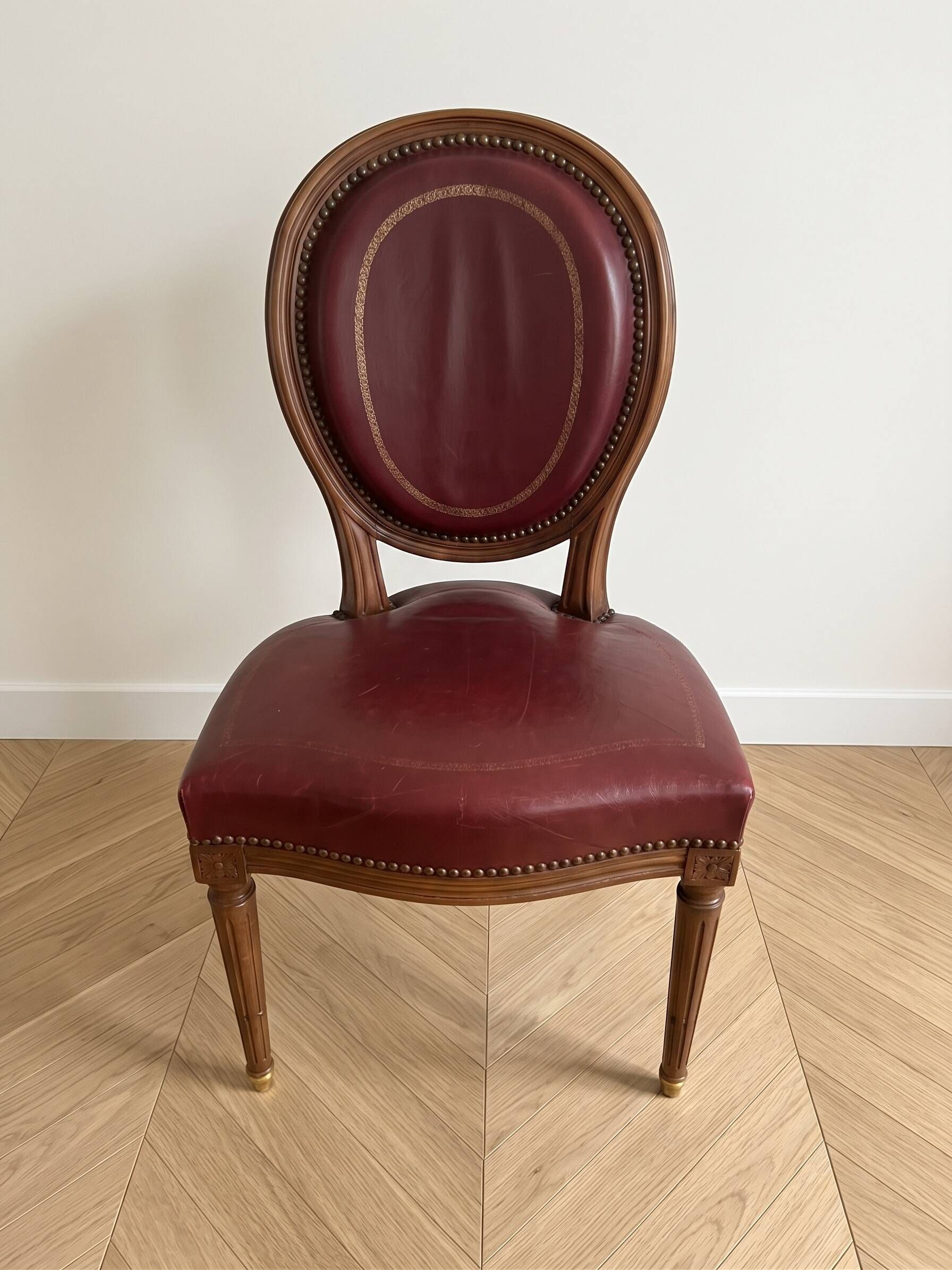 Set of 6 Louis XVI style medallion chairs and armchairs in burgundy leather.