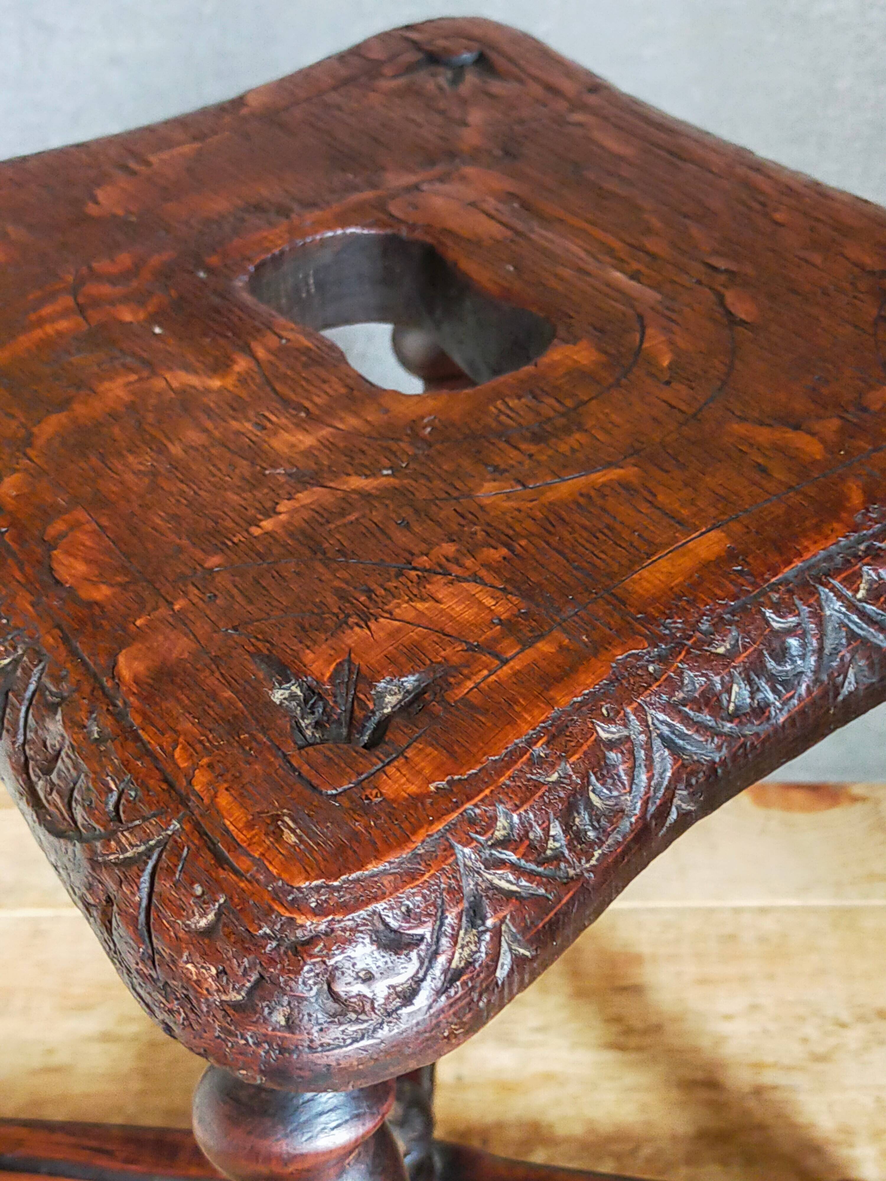 Antique stool in turned and carved solid wood