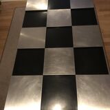 Coffee table with stainless steel checkered top and black formica