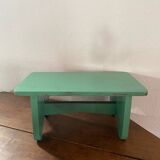 Vintage wooden footrest in mint green.
