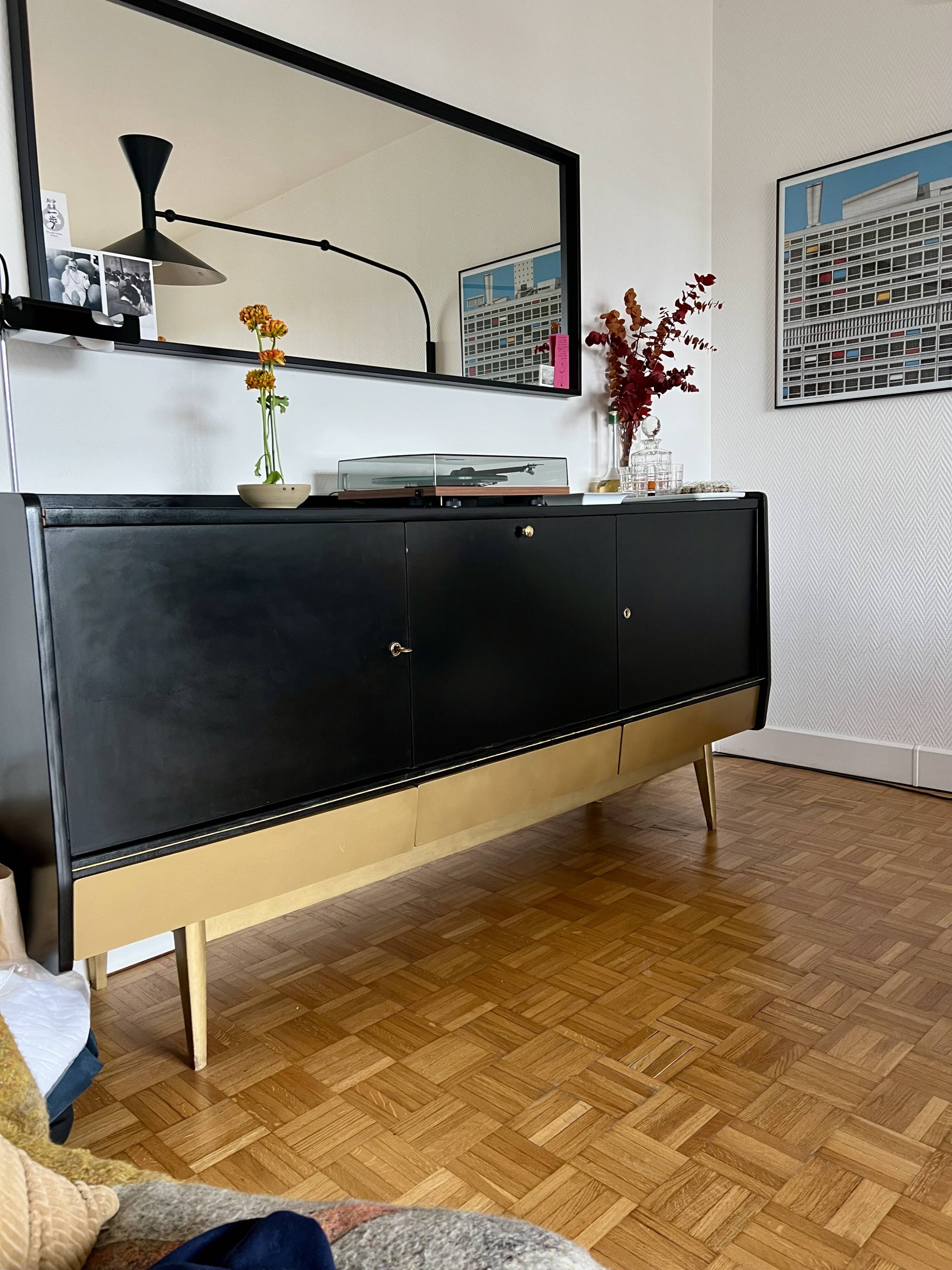 Black buffet cabinet including a bar and 3 drawers.
