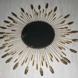 Round sun mirror with pearl rays and leaves