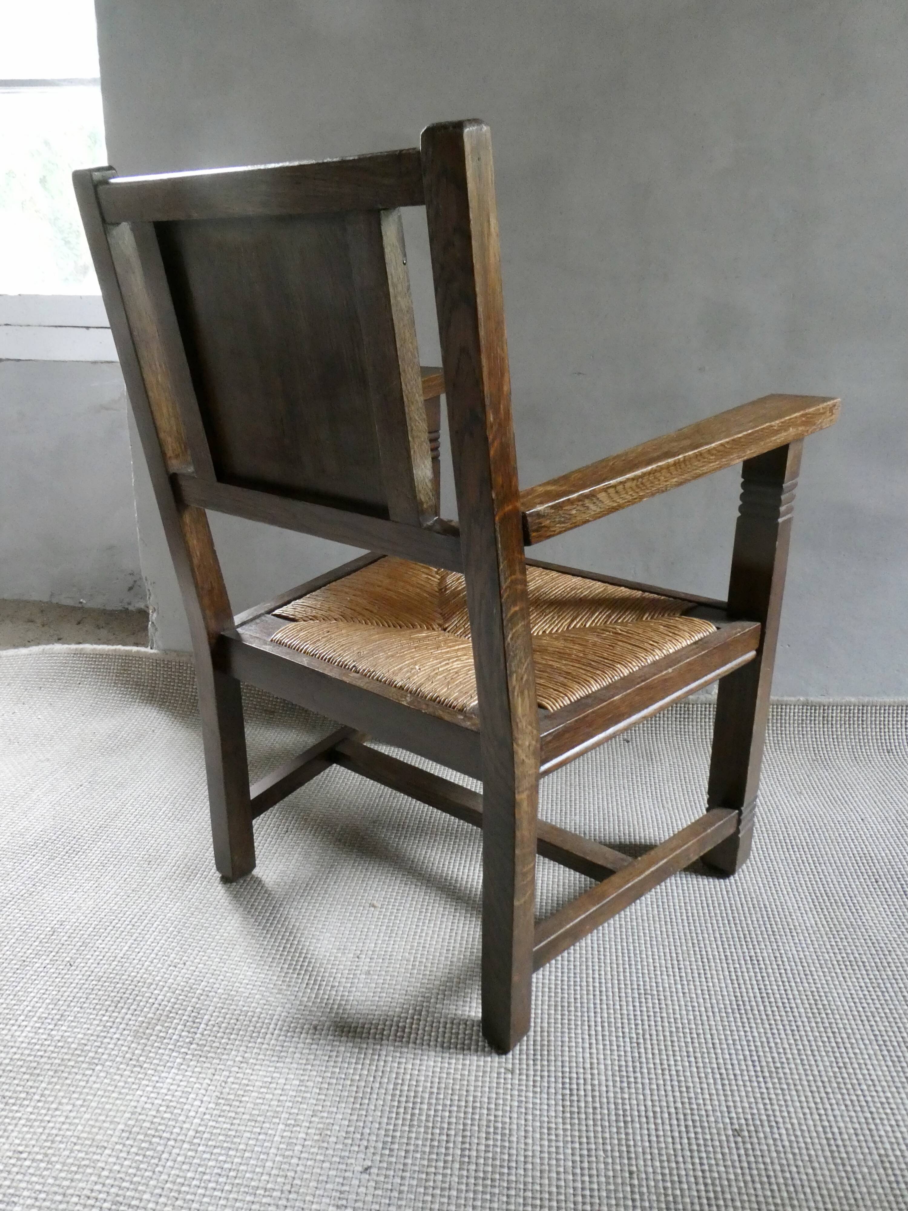 Armchair in carved solid wood with straw seat