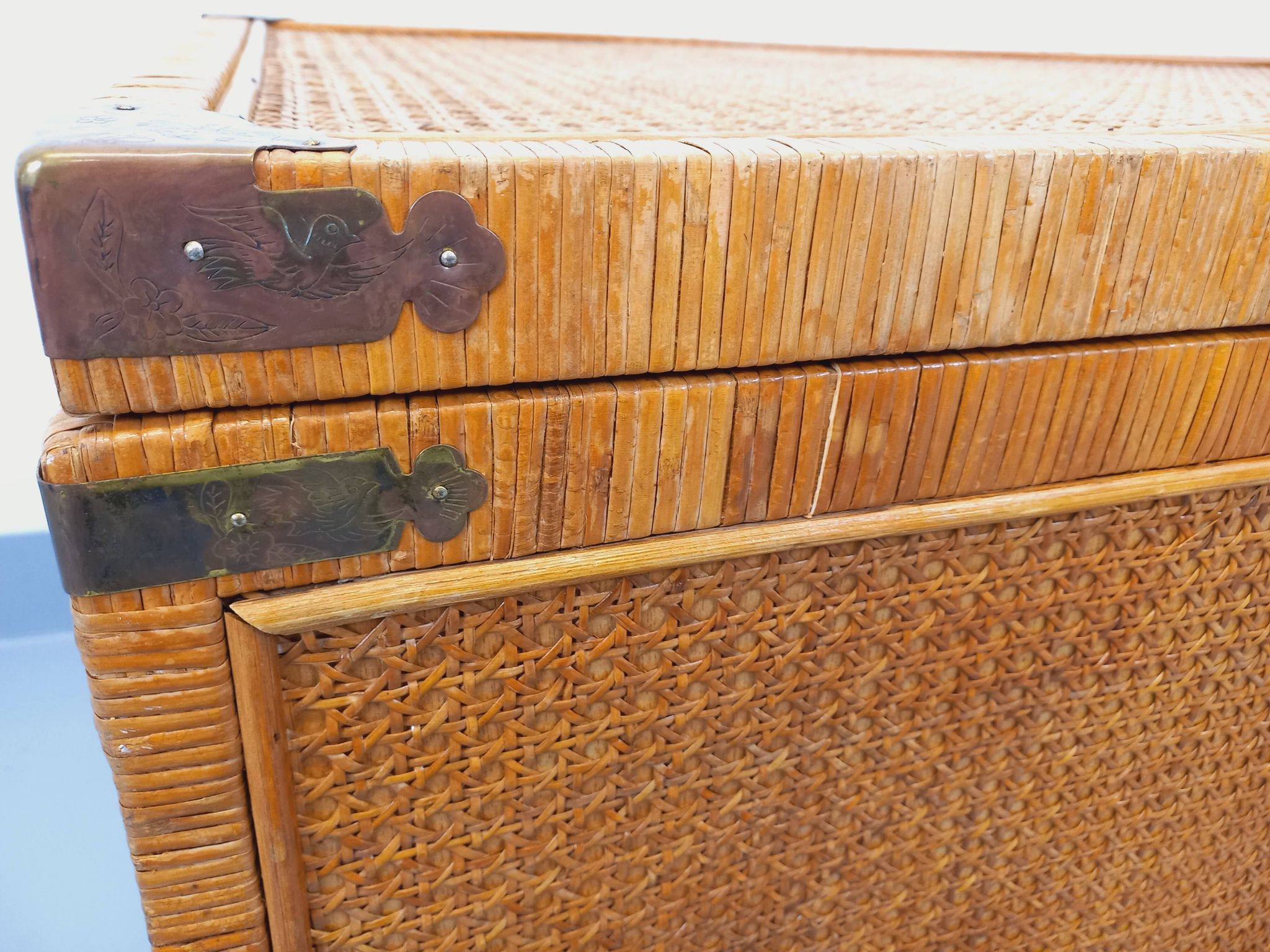 Vintage trunk in wood, rattan, caning, and brass.