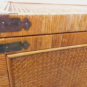 Vintage trunk in wood, rattan, caning, and brass.