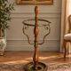Umbrella stand and English-style wooden and brass canes, 20th century.