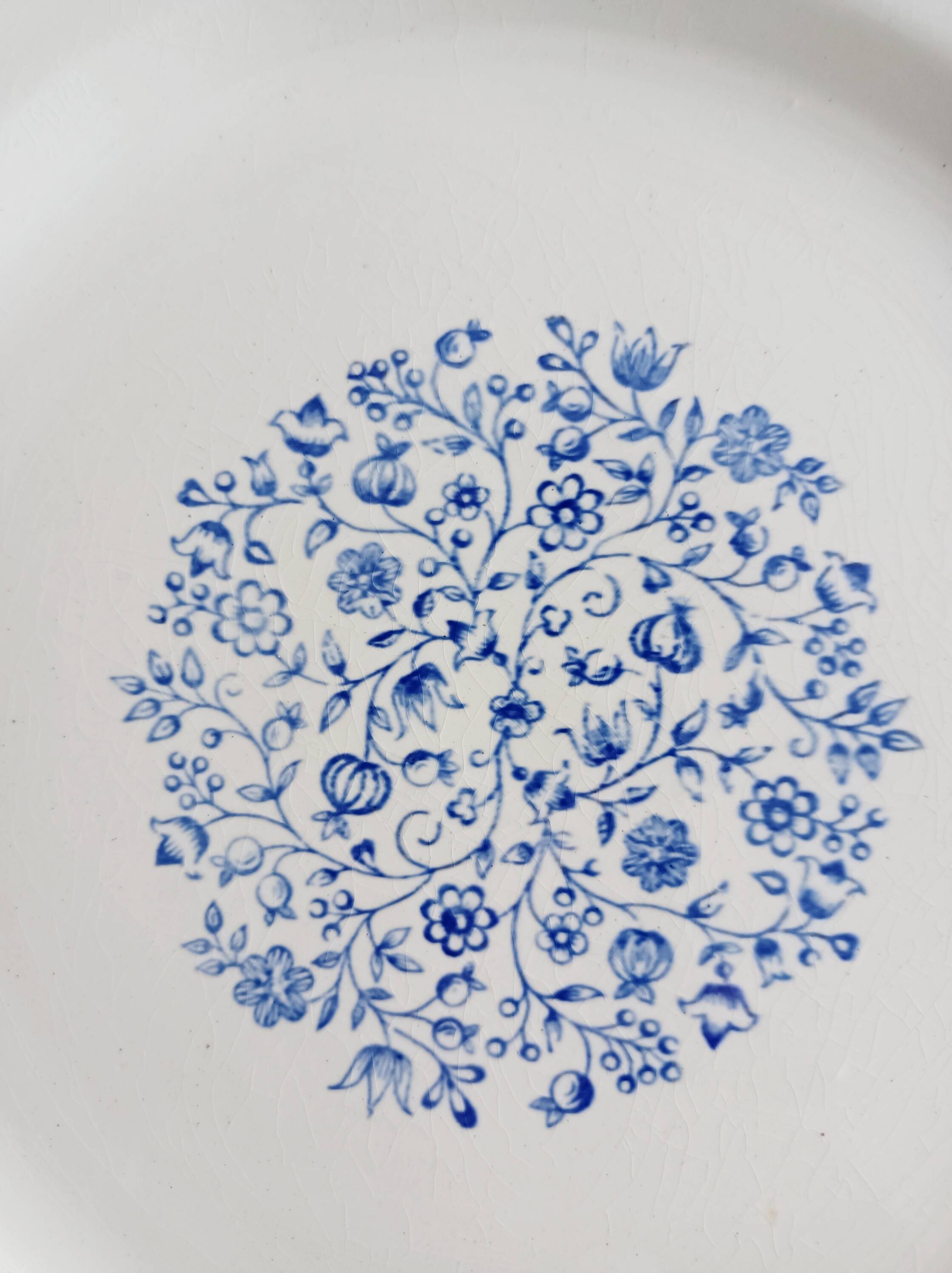 Round antique earthenware dish with floral decoration