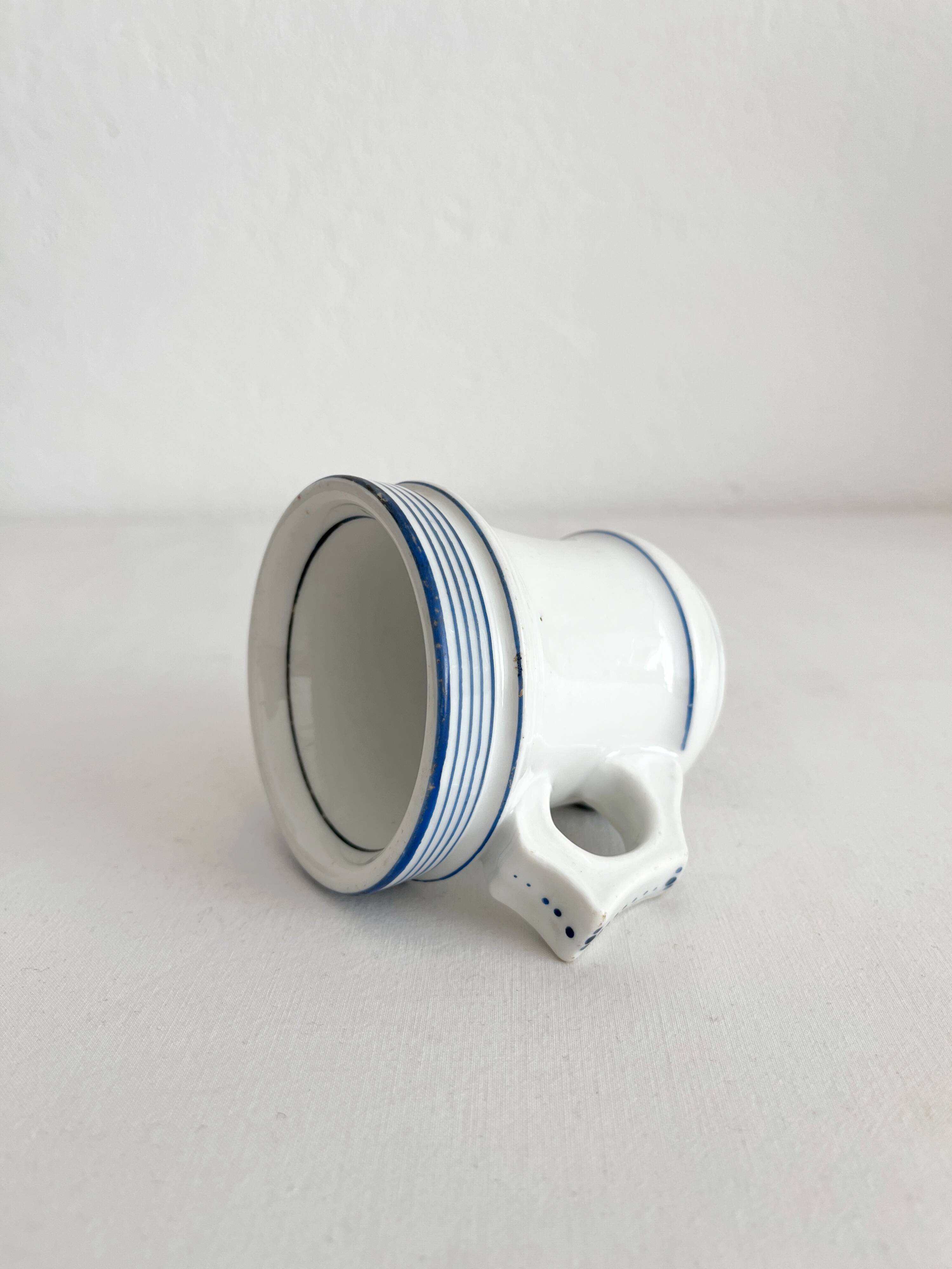 Antique porcelain teacup with blue rims, 19th century