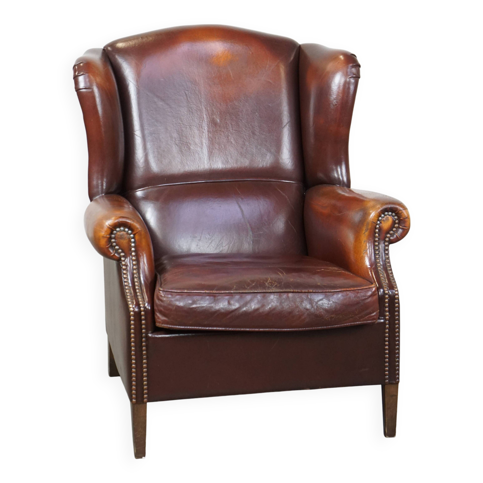 Dark English style sheepskin wingback chair with character and patina