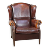 Dark English style sheepskin wingback chair with character and patina