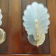 Pair of wall lights with frosted glass and brass shell design.