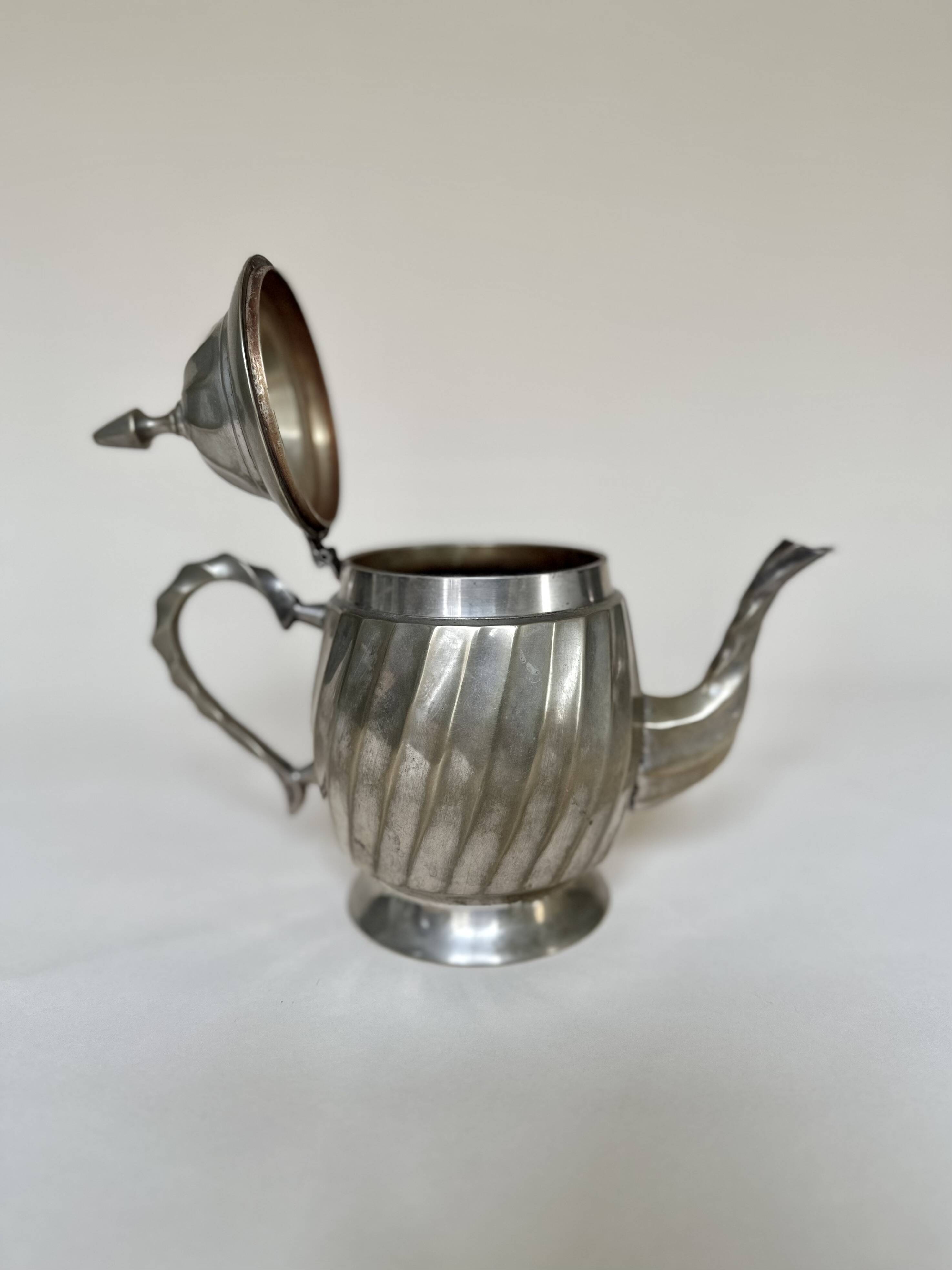 Silver-plated metal teapot with fluted body in Art Deco style