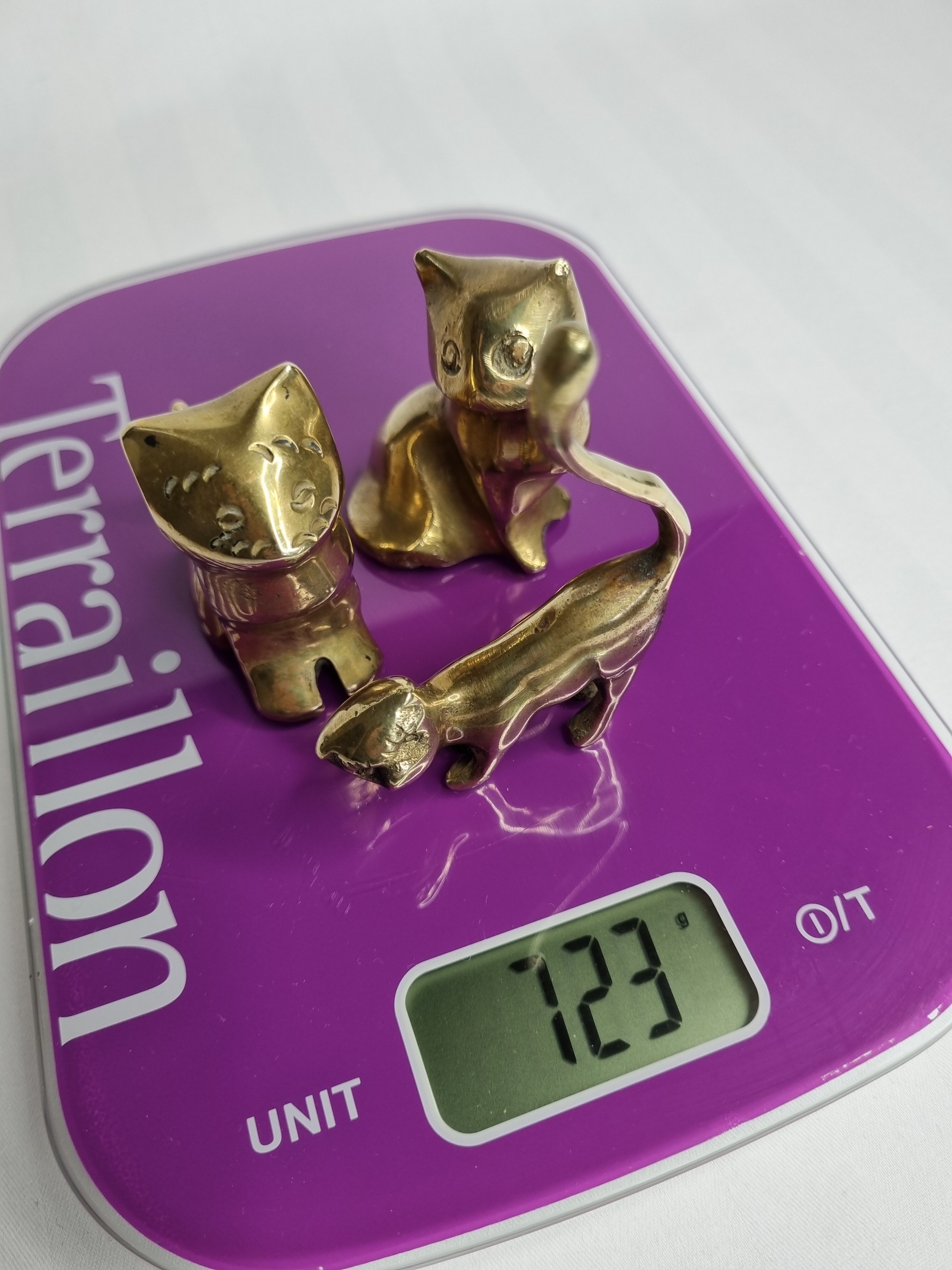 Set of three brass cats