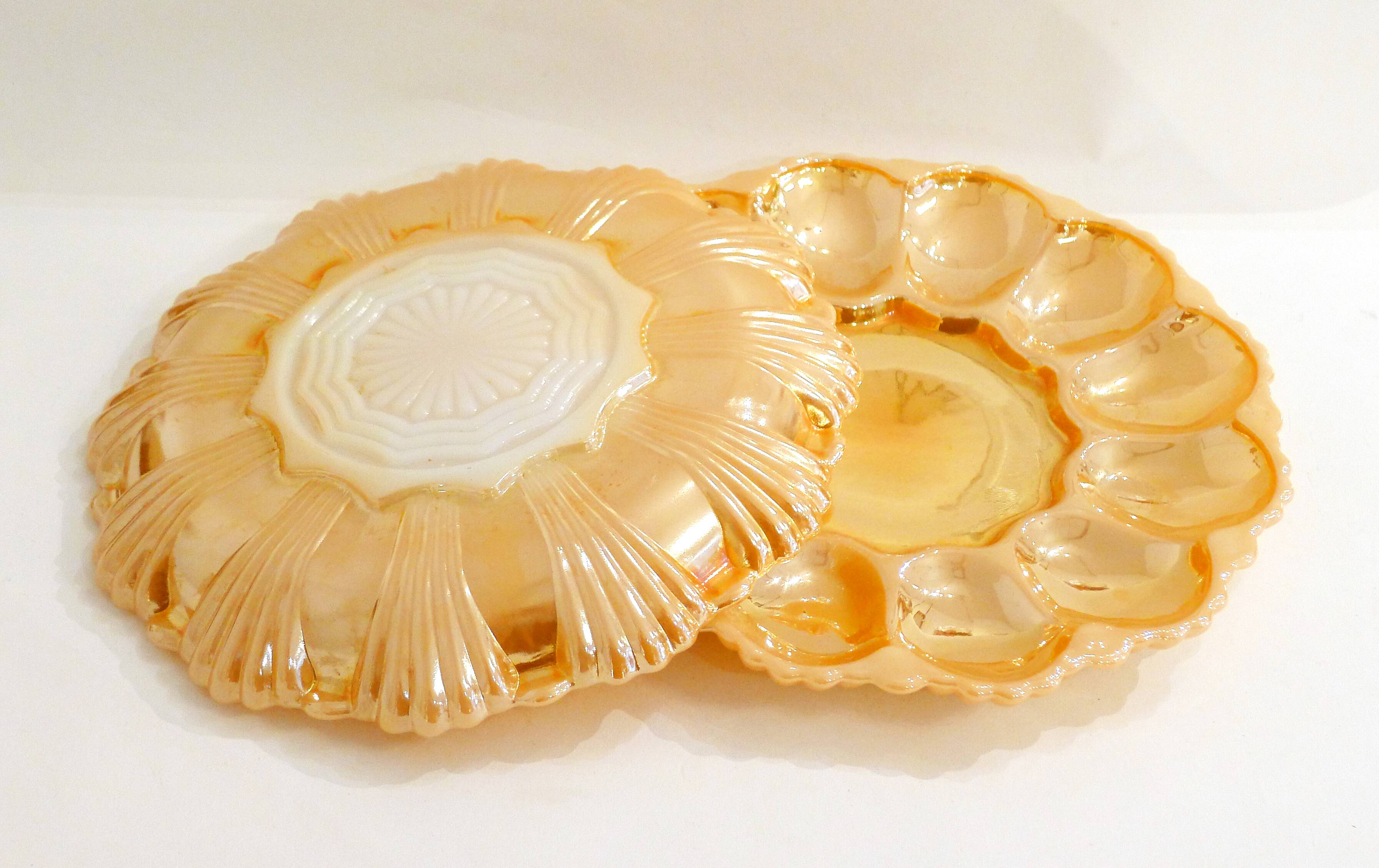 Pair of iridescent orange glass egg plates