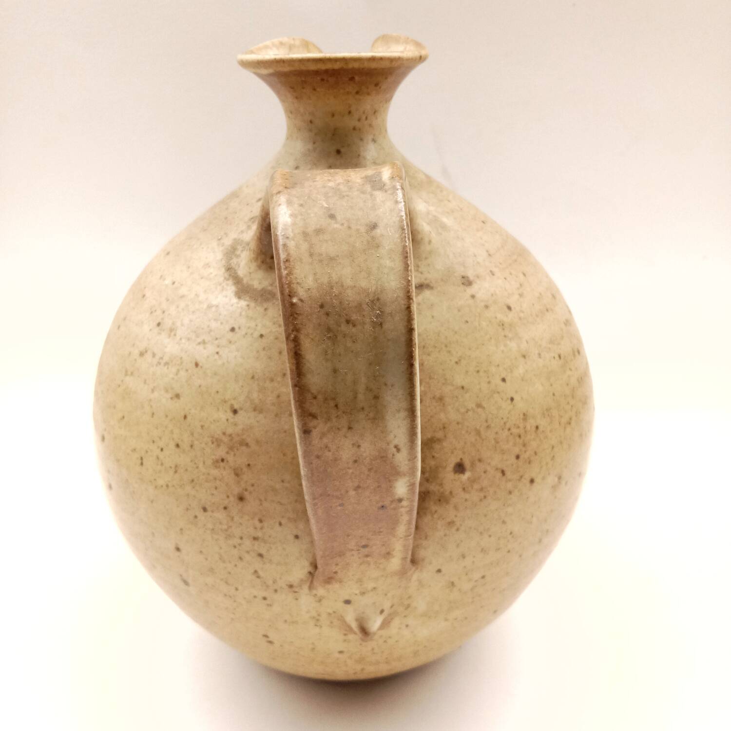 Vintage speckled brown stoneware jug in a round shape.