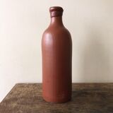 Old bottle in hazelnut Brown sandstone with label