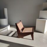 Reclined armchair in canned teak in natural wood