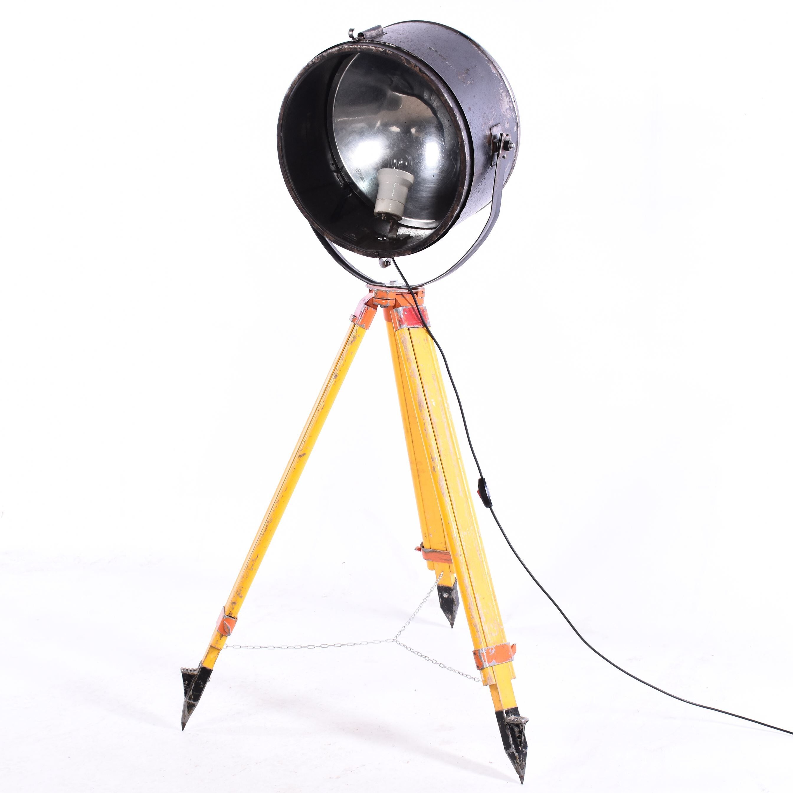Old industrial spot on wooden tripod