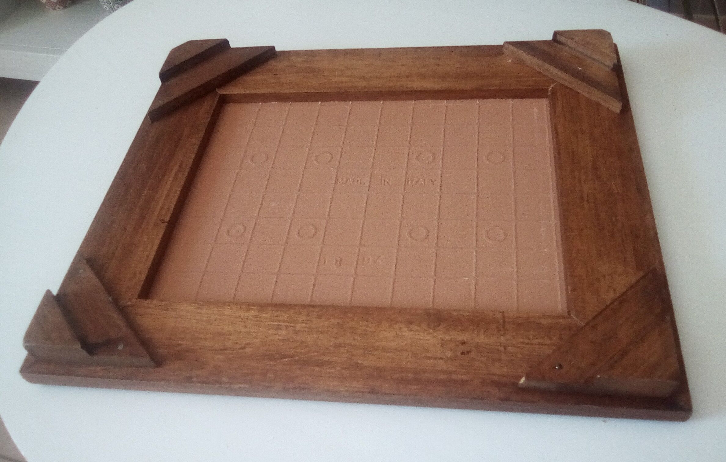 Underside of vintage wood and ceramic dish