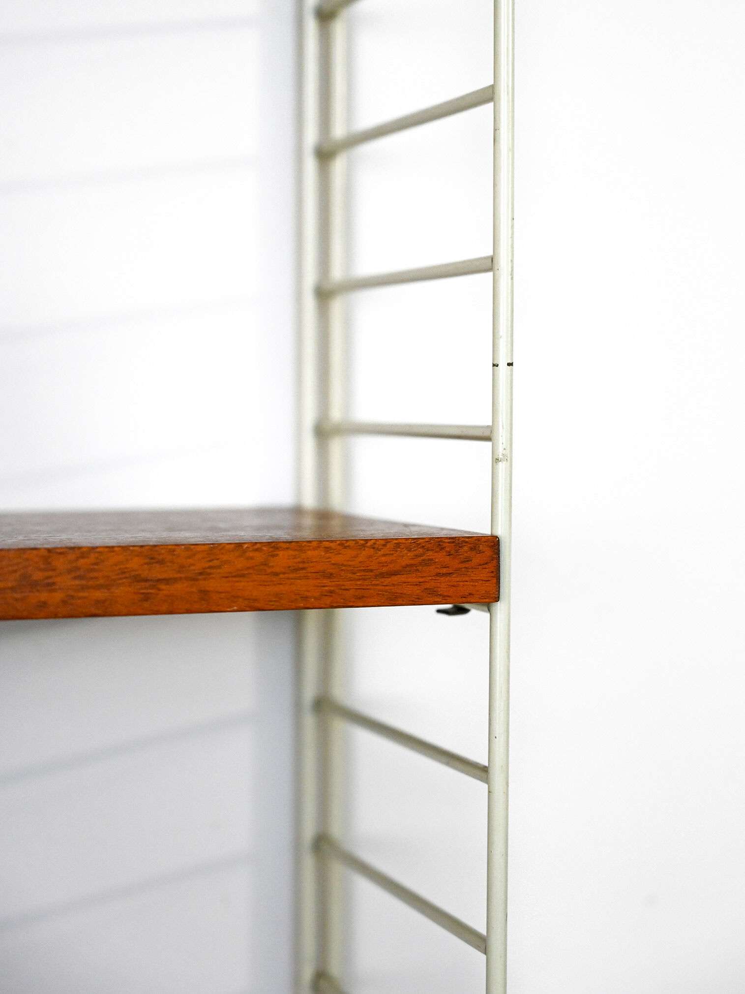 'string' bookcase with metal frame