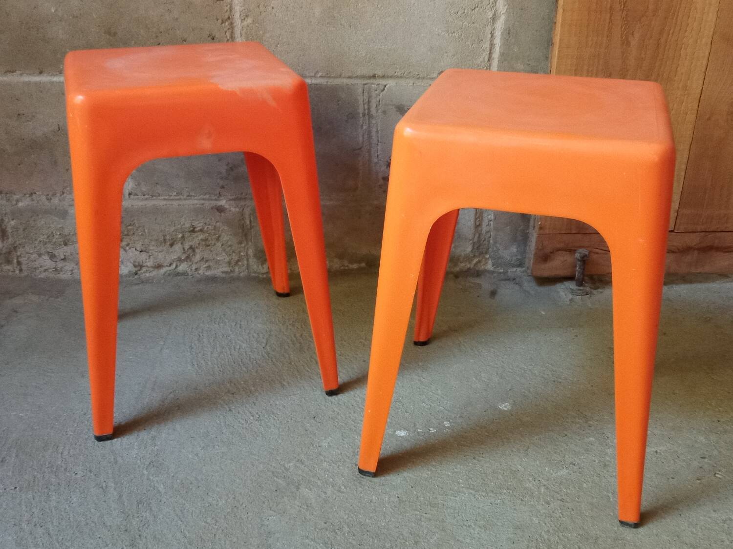 Pair of AMI stools in orange plastic