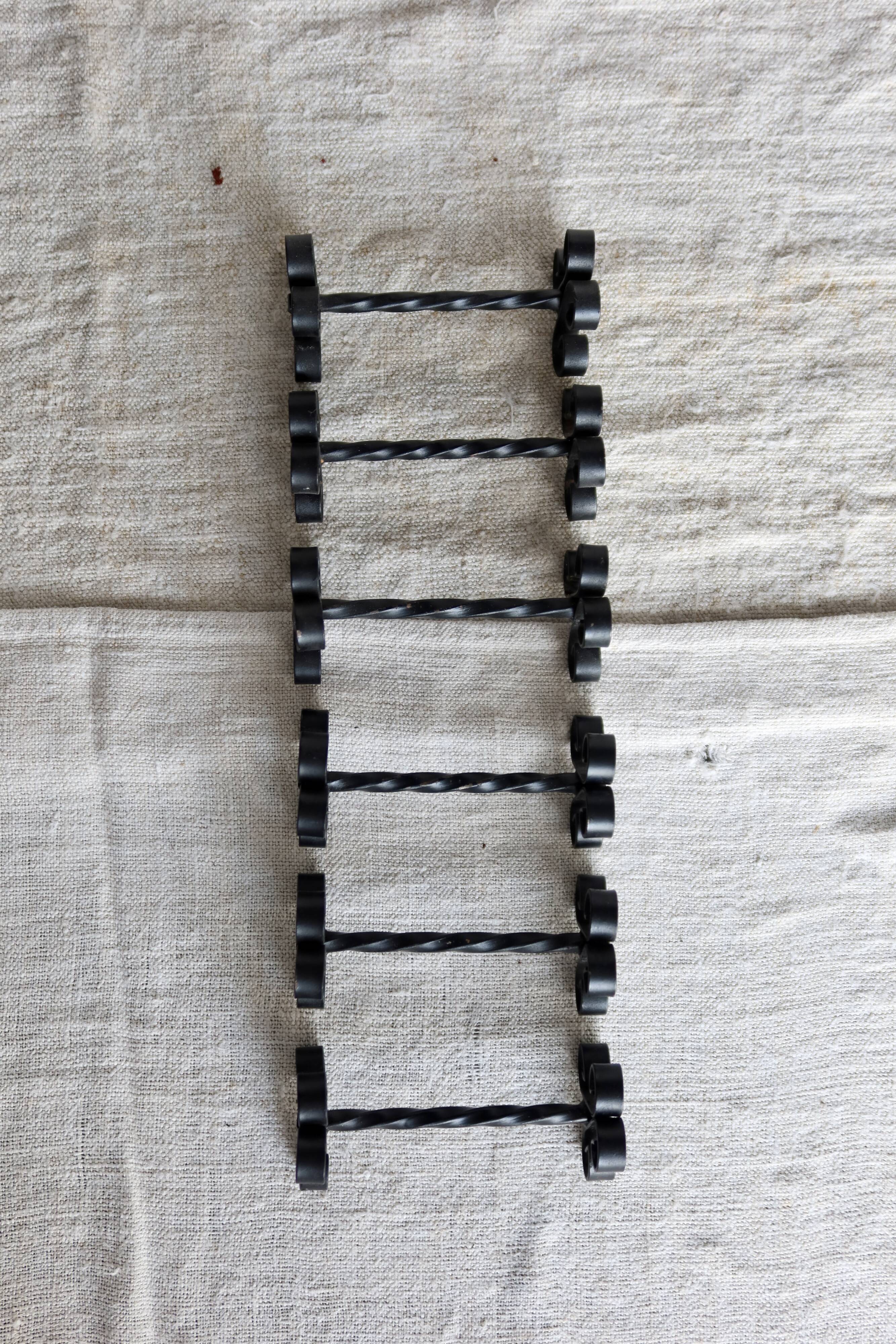 6 vintage black metal knife rests with scrollwork decoration