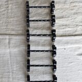 6 vintage black metal knife rests with scrollwork decoration