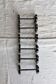 6 vintage black metal knife rests with scrollwork decoration