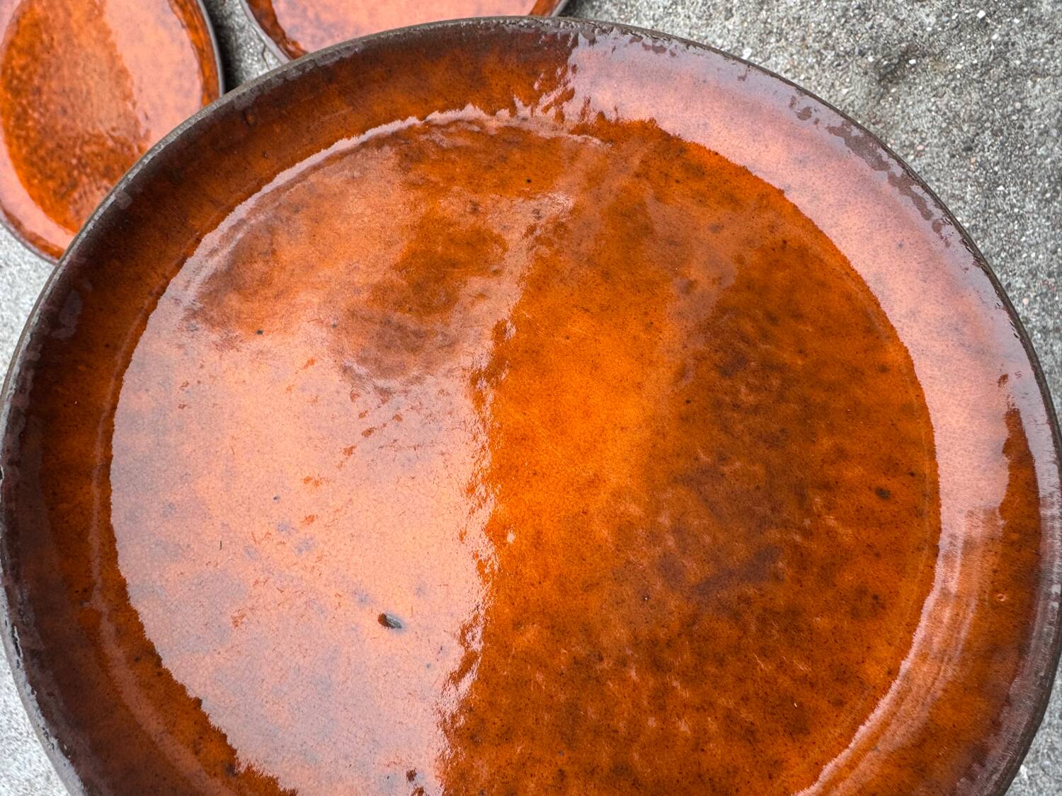 Orange glazed ceramic plates from the 1970s