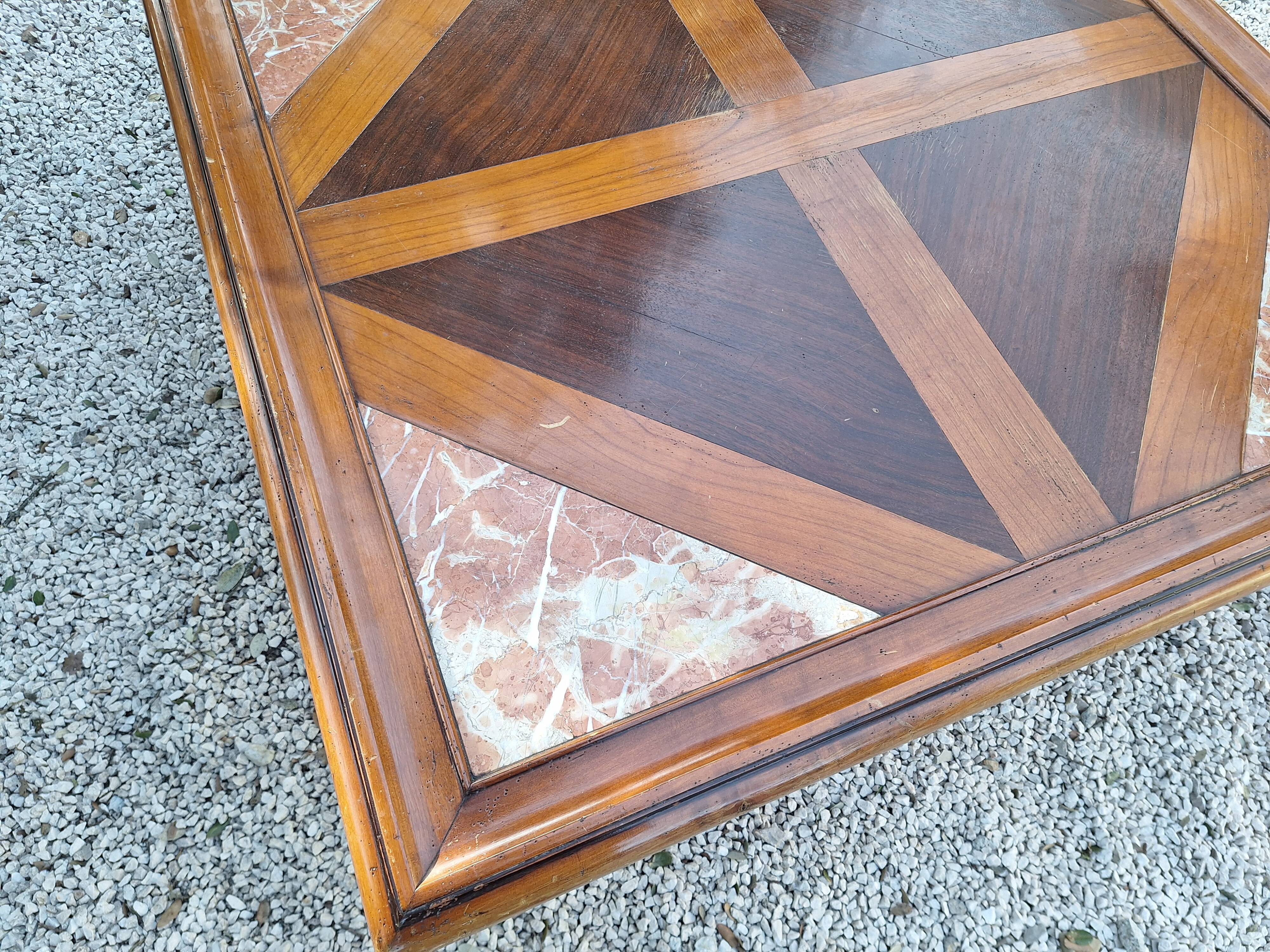 Coffee table with wood marquetry and marble inlays.