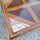 Coffee table with wood marquetry and marble inlays.