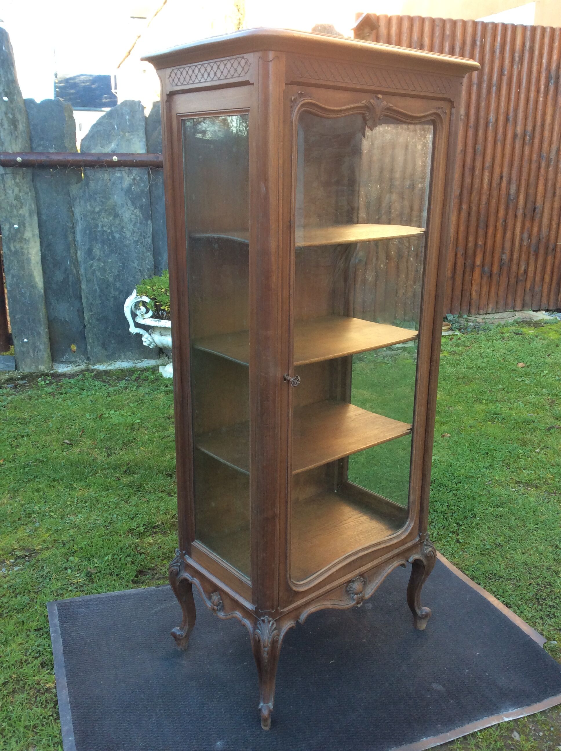 Louis XV Rocaille style showcase in solid walnut, beveled door glass.