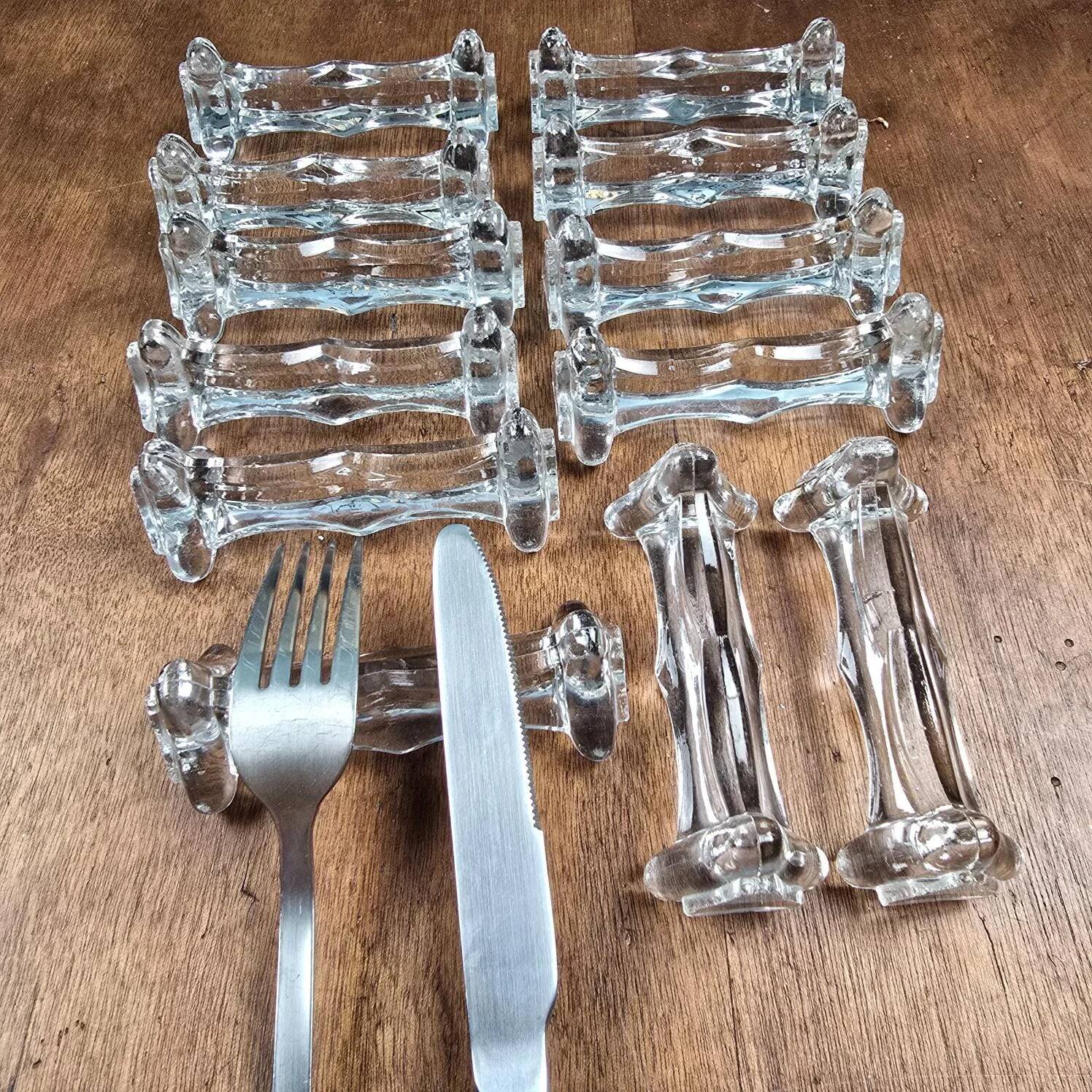 Set of 12 antique knife and fork rests in thick transparent glass.