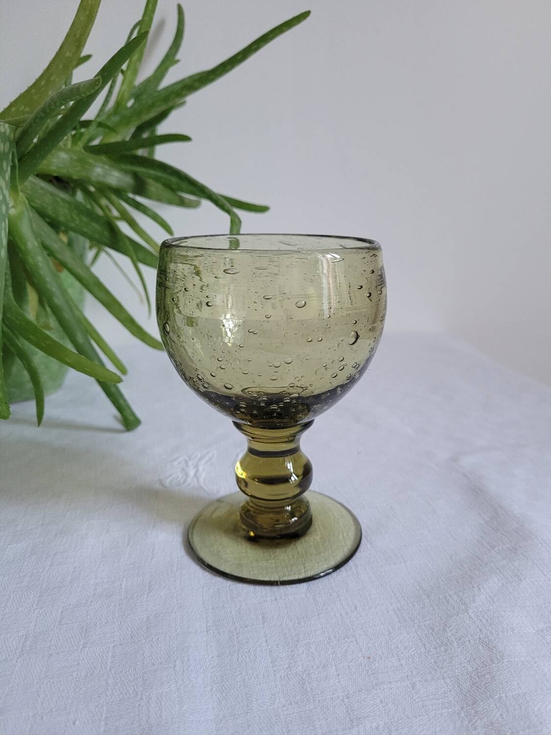 Footed glass made of blown glass