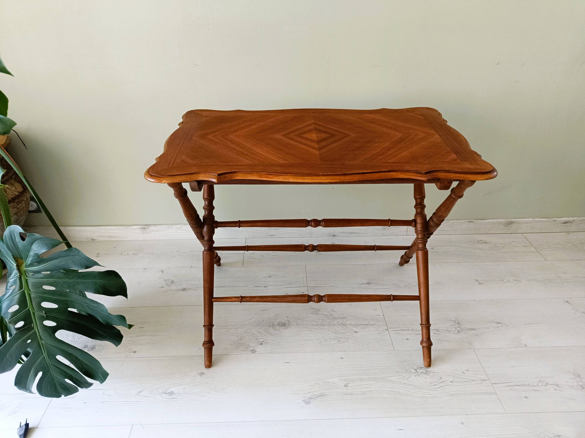 Vintage folding table with turned legs.