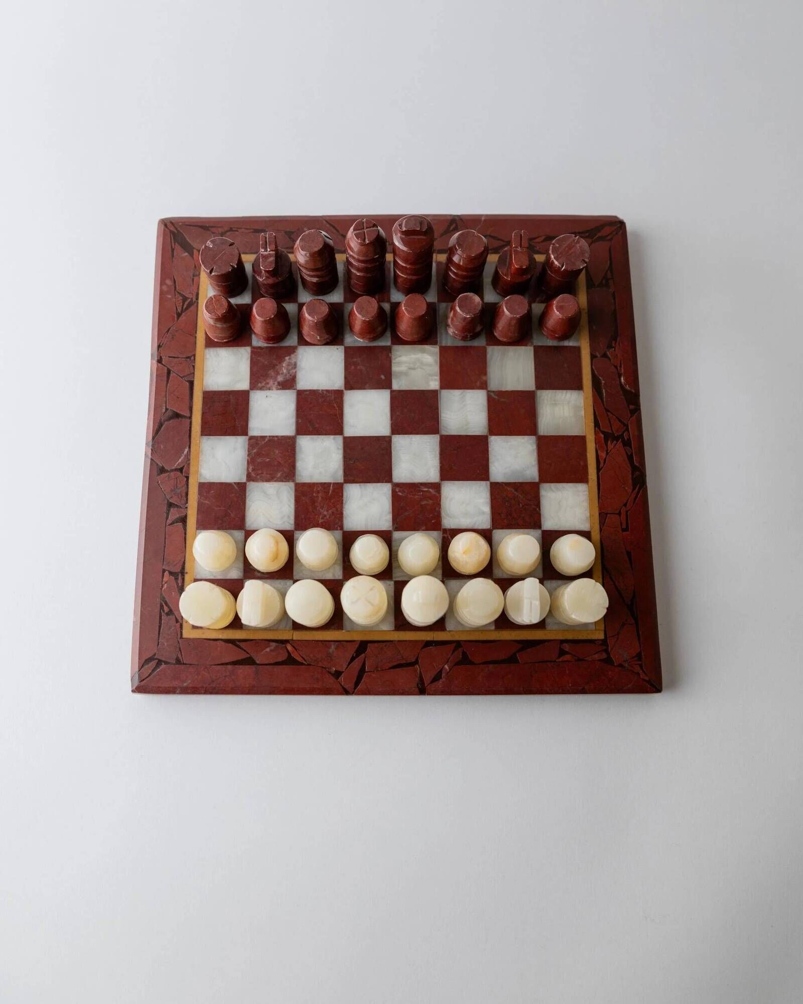 Vintage marble chess set from the 1960s, cream, burgundy and gold board with metal inlay, stone pieces.