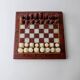 Vintage marble chess set from the 1960s, cream, burgundy and gold board with metal inlay, stone pieces.