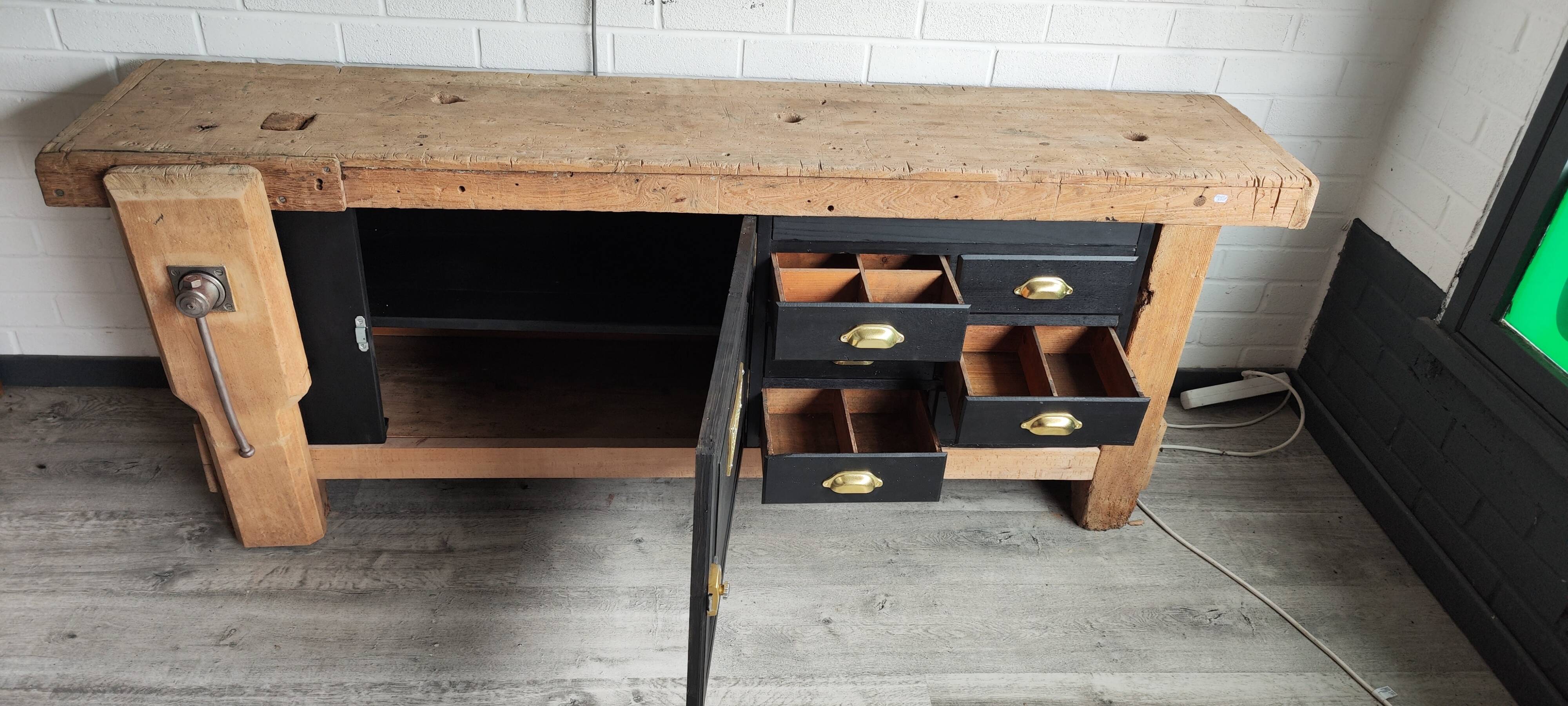 Old workbench furniture with six drawers and a door