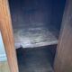 Vintage bedside table in the shape of a wooden column and a gray marble top