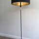 Designer floor lamp in black lacquered metal and brass