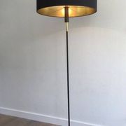 Designer floor lamp in black lacquered metal and brass