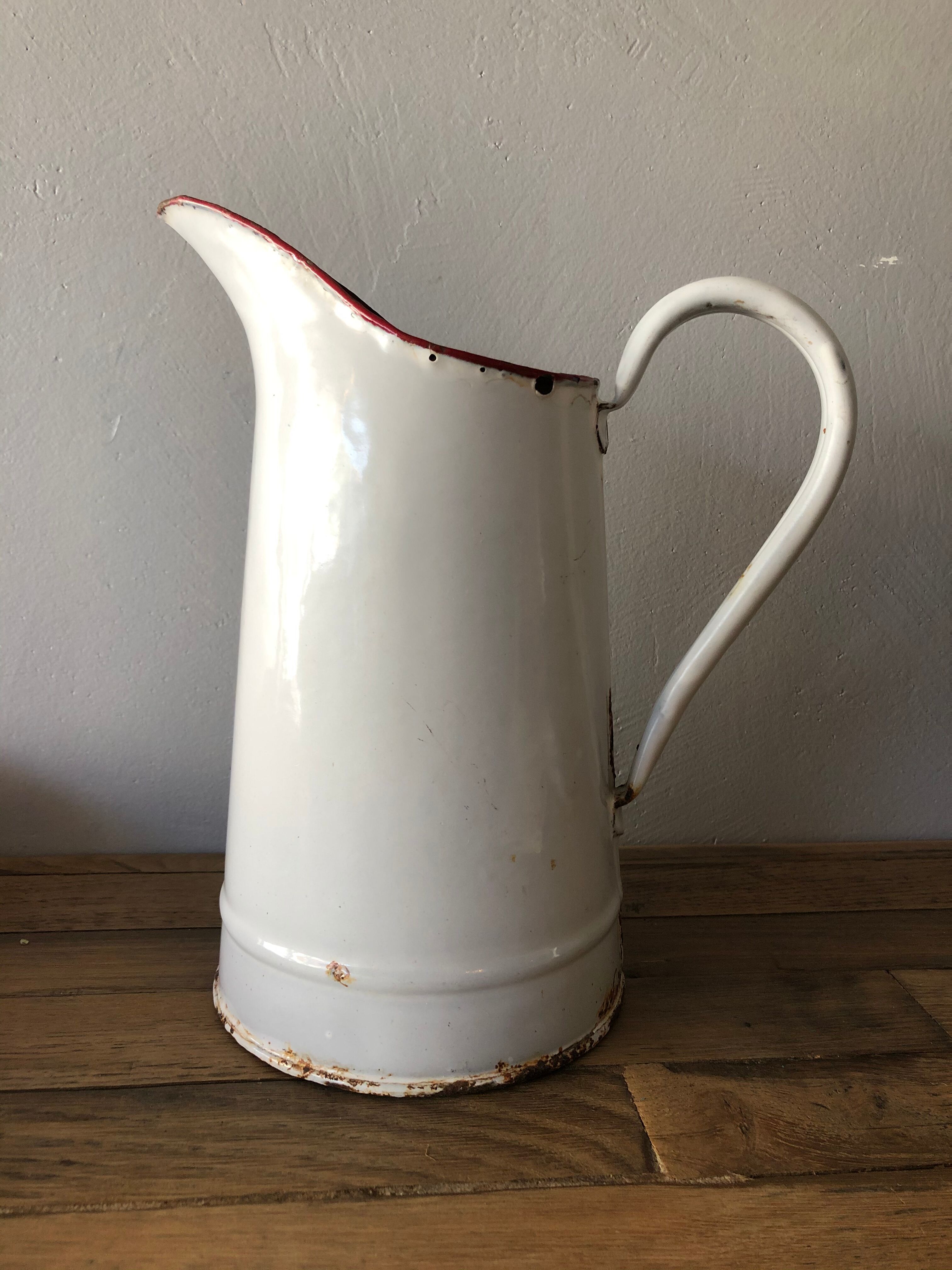 Old pitcher in enamelled sheet metal