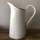 Old pitcher in enamelled sheet metal