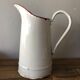 Old pitcher in enamelled sheet metal