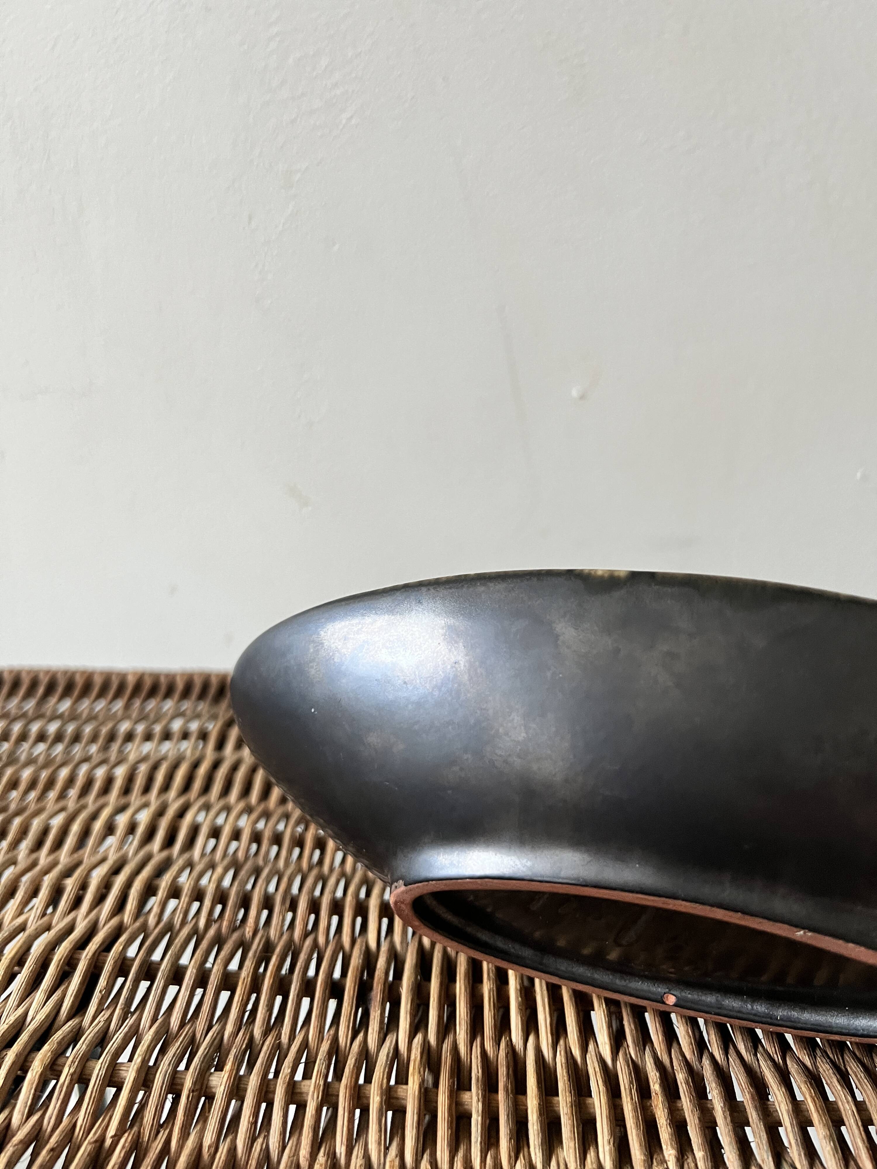 Pale yellow and black ceramic bowl / empty pocket signed by the artist