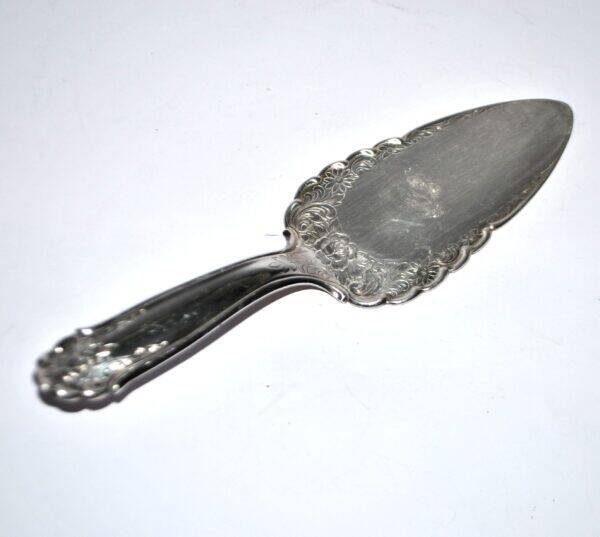 Vintage silver-plated pie server with rose decoration.