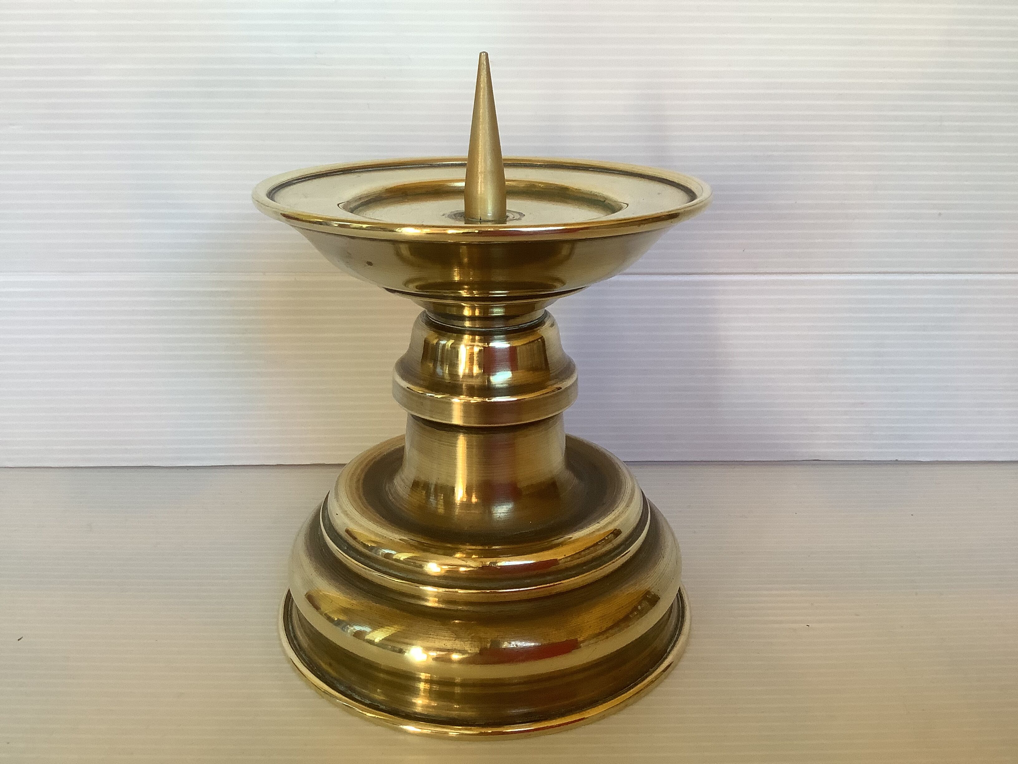 Old brass candle pique