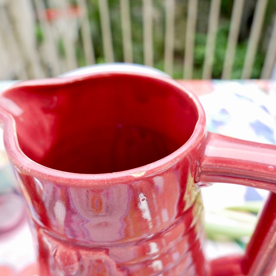 Burgundy/red ceramic pitcher