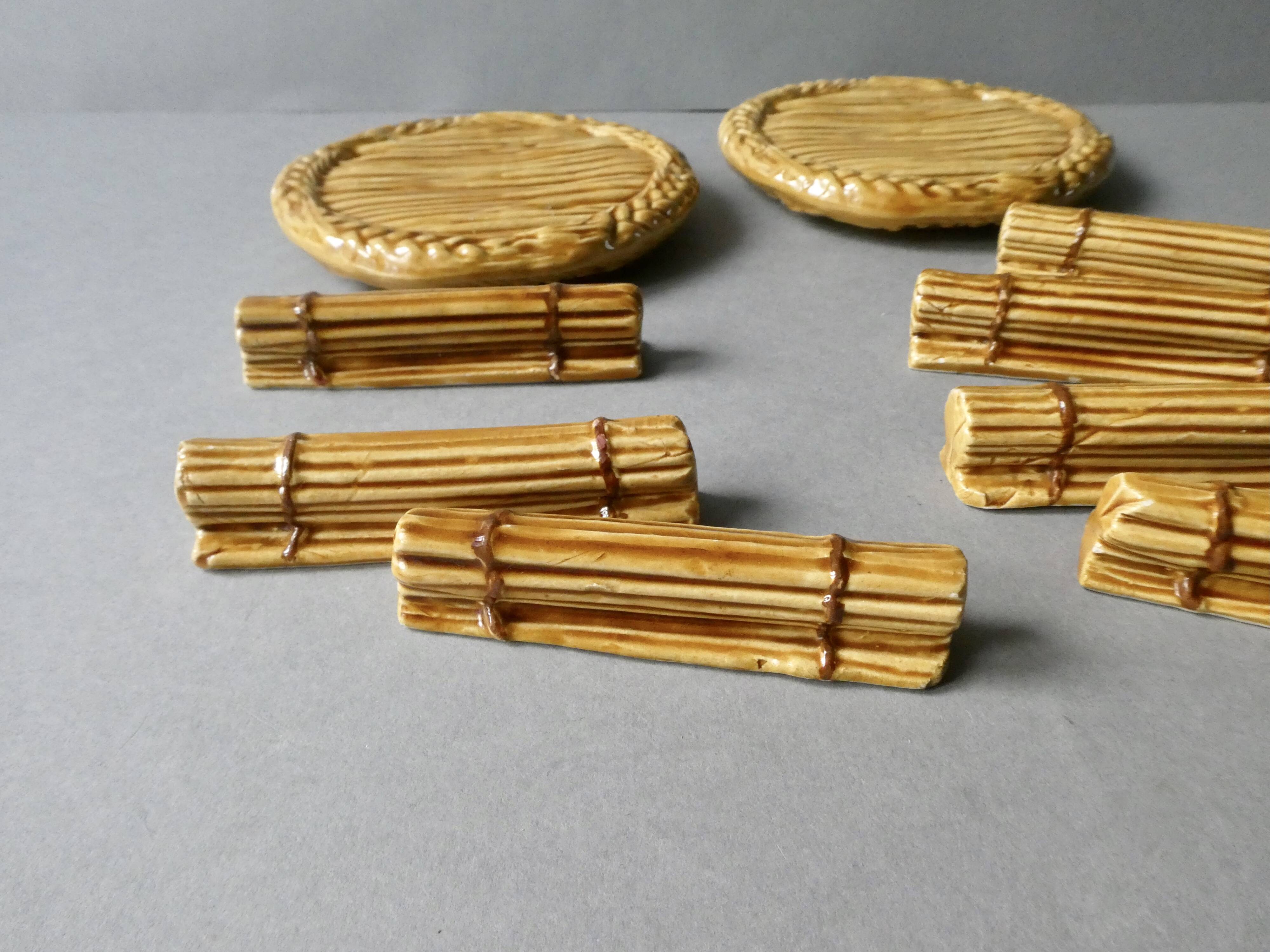 12 knife rests and 2 bottle coasters in earthenware