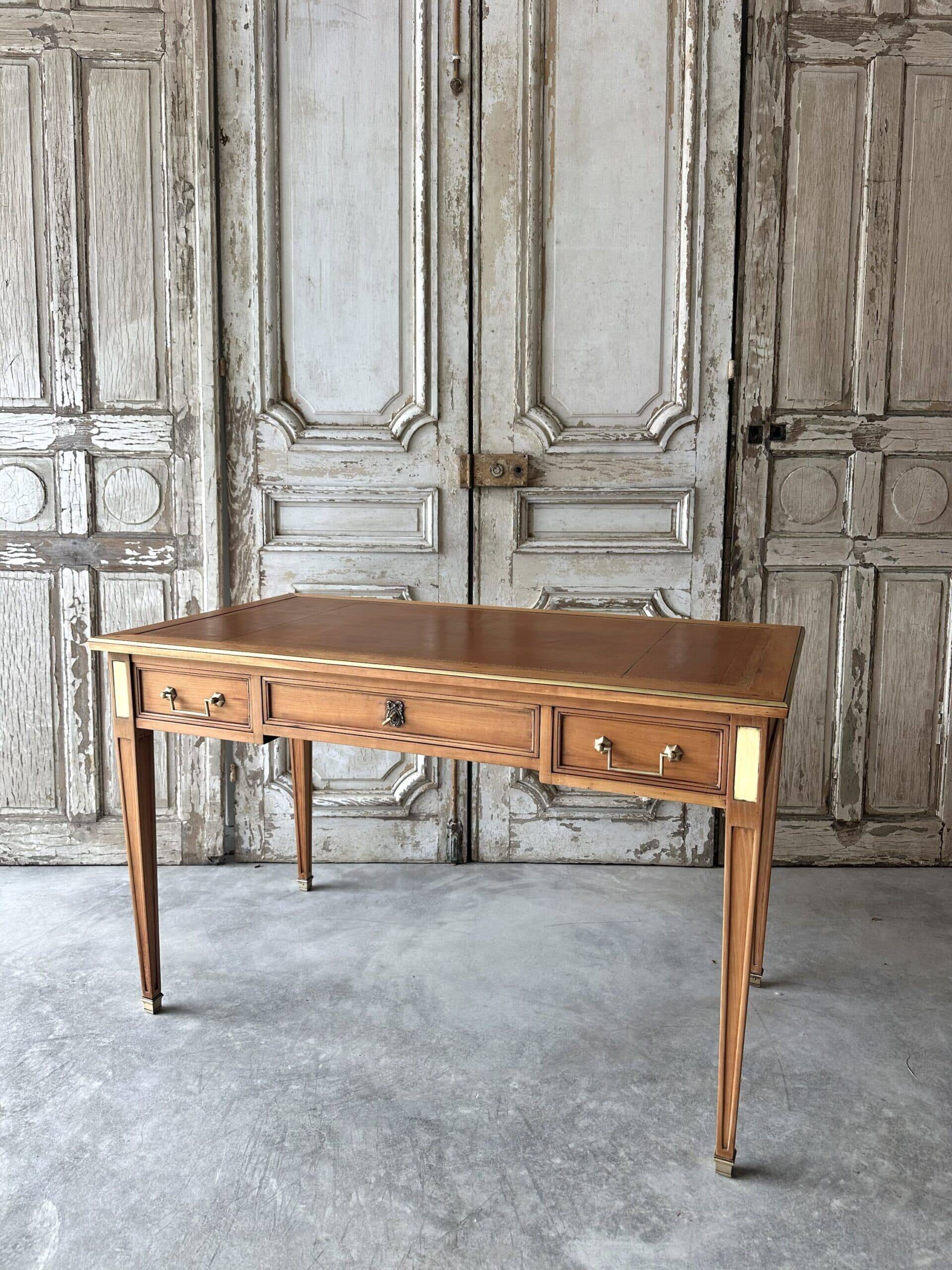 Directoire style flat desk circa 1960 in light cherry wood.